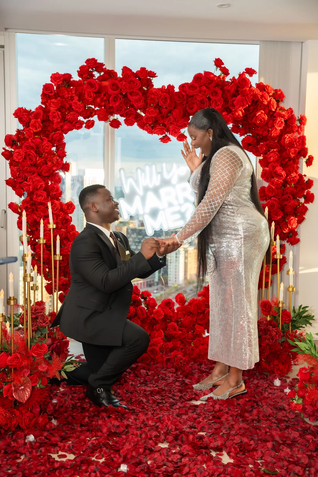 Godwin proposing to Flourish under a heart of red roses